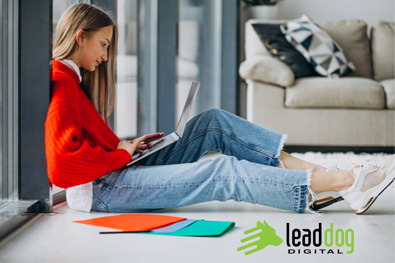 An illustration for digital learning. A girl is sitting on the floor in front of a white couch, holding a laptop in her nap and learning online.