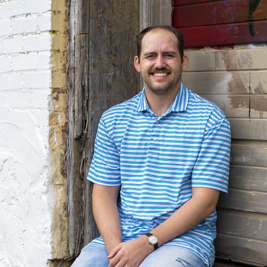 Statler Lewis - digital marketing specialist at Lead Dog Digital Tyler TX, sitting and wearing blue shirt.